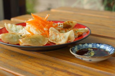 Potstickers with dip on a wooden table