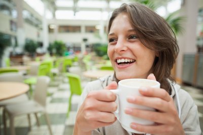 Woman holding cup of coffee
