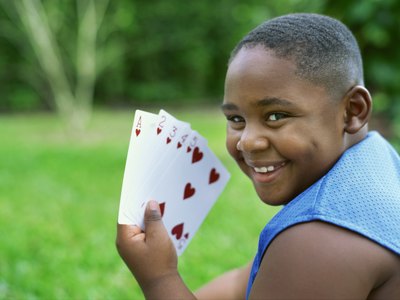 child with playing cards