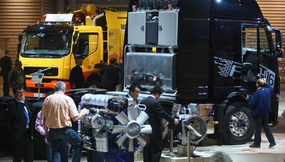 Commercial trucks on display at a trade fair.