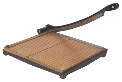 A paper cutter provides a more consistent cut than a scissors.