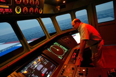 A merchant marine charts the course of the vessel.