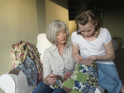 Grandmother and granddaughter looking at quilt