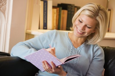 Woman writing in a journal