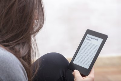 Image of a woman reading an electronic book.