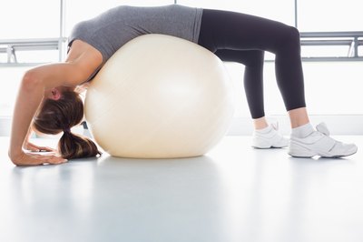 Woman stretching on yoga ball