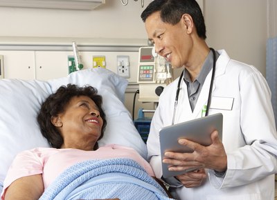 Woman talking with doctor after surgery