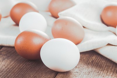 Eggs on a tablecloth and wooden table