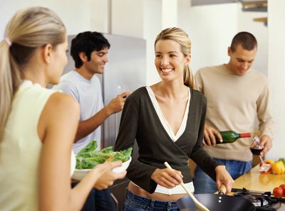 Friends cooking in kitchen