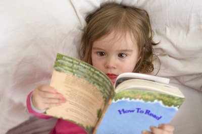 young girl learning to read