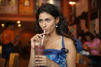Young woman drinking smoothie
