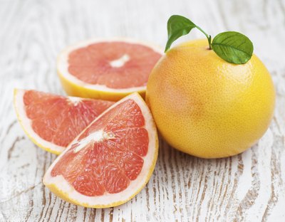Sliced grapefruit on table.