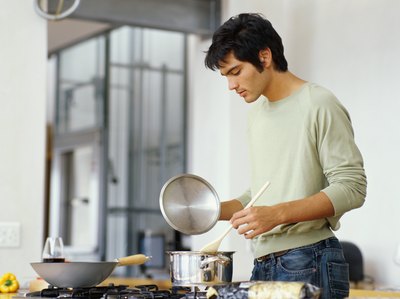 Man stirring chowder in pot