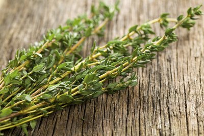 Close-up of thyme herb on wooden counter.