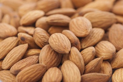A close up of a pile of almonds.