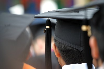 A close-up of graduates listening to a commencements speech.