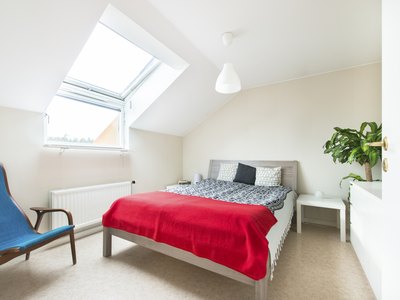 A hanging lamp in a well lit bedroom.