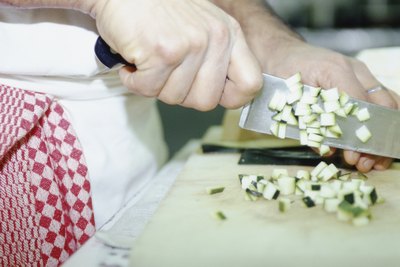 Close-up of chef chopping vegetables.