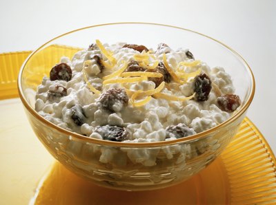 A bowl of Cottage cheese with lemon.