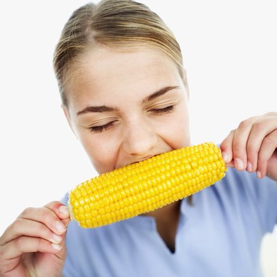 Teen eating corn