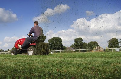 A man driving a lawn mower
