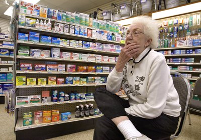 Woman waiting for her prescription at pharmacy