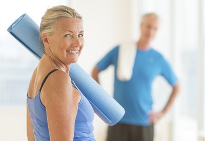 Older couple with yoga mats