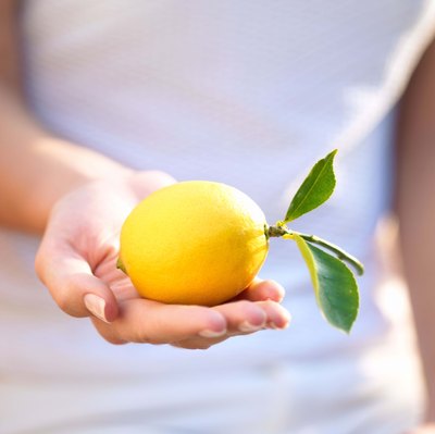 Woman holding lemon