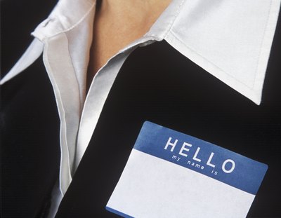 A woman has a blank name tag on her blazer.