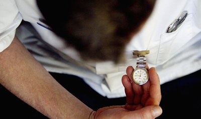 Doctor with pocket watch in London, England