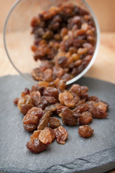 Raisins spilling from a glass bowl
