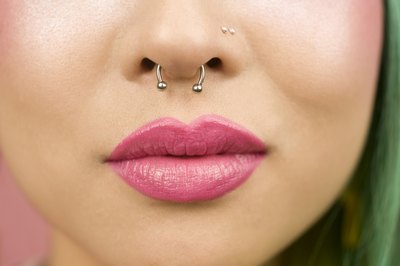 Close up of nose piercings.
