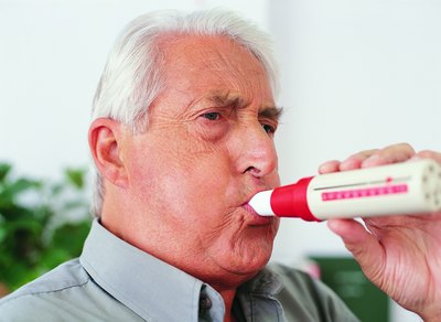 Man testing breathing with a spirometer