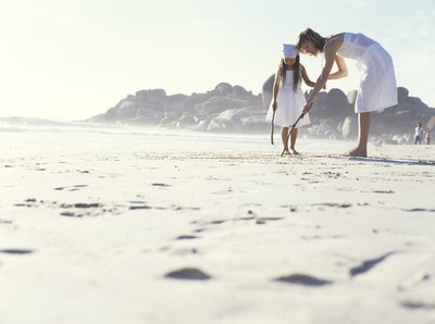 6 year old girl playing on beach