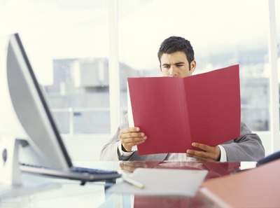 Young man analyzing information in an office.