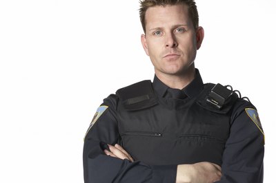A police officer wears a bullet proof vest.