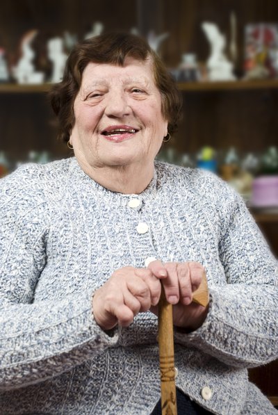 A smiling grandmother wearing a knit sweater.