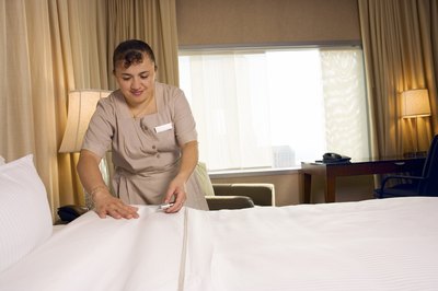 Housekeeper making bed