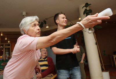 Elderly woman playing Wii