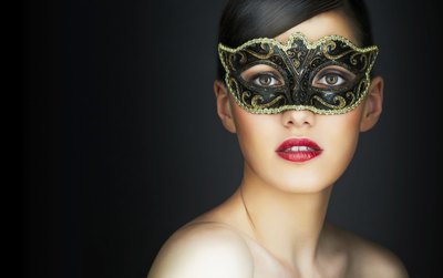 Young woman in a masquerade mask.