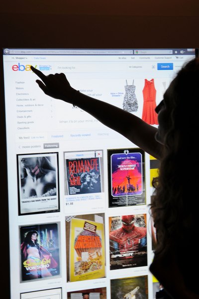 Woman using eBay feed experience to customize home page