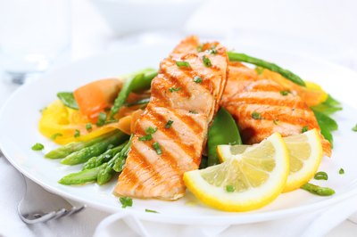A plate of grilled salmon with vegetables.