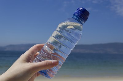 Close-up of bottled water at the beach