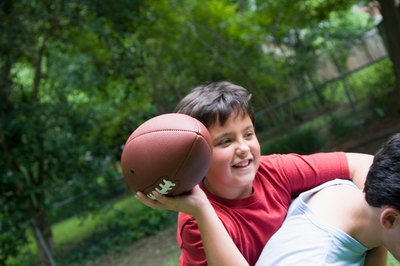 Teenage boy throwing football