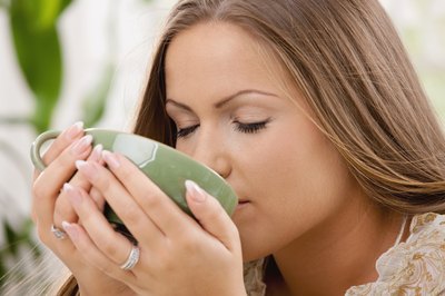 woman drinking hot lemon water