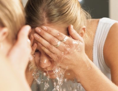 Rinsing eyes with warm water