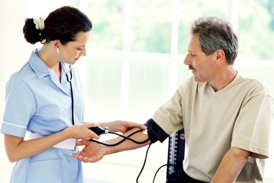 Patient having blood pressure tested by a nurse.