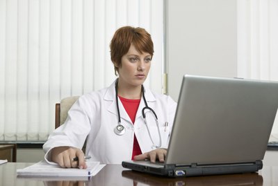Doctor looking at laptop