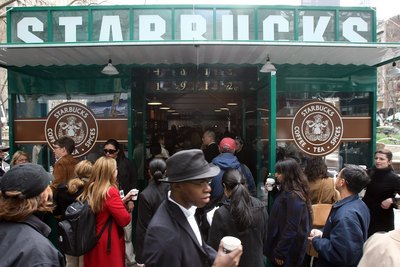 Customers gather outside a Starbucks store in Bryant Park in New York City