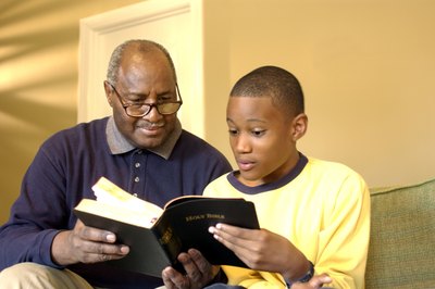 Grandfather and grandson reading bible